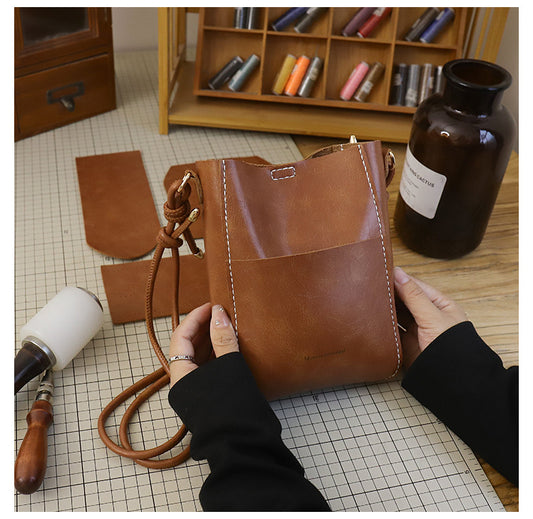 Handmade material bag fashionable and simple solid color bucket messenger bag