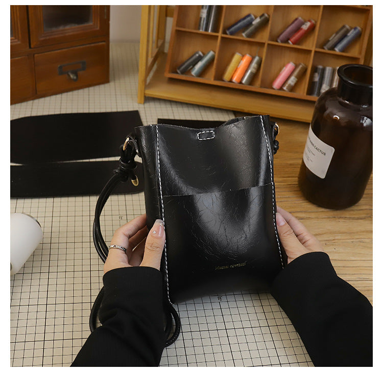 Handmade material bag fashionable and simple solid color bucket messenger bag