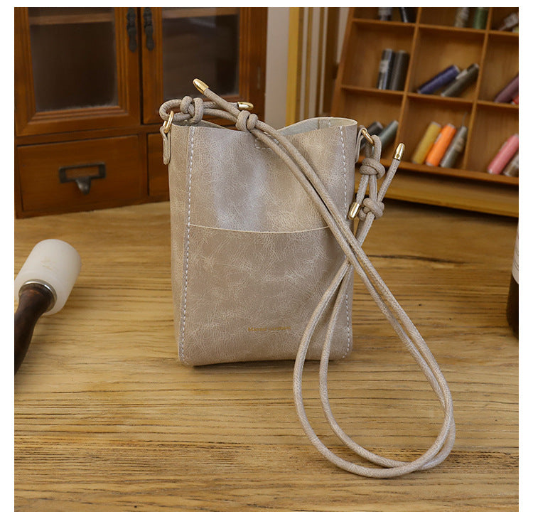 Handmade material bag fashionable and simple solid color bucket messenger bag